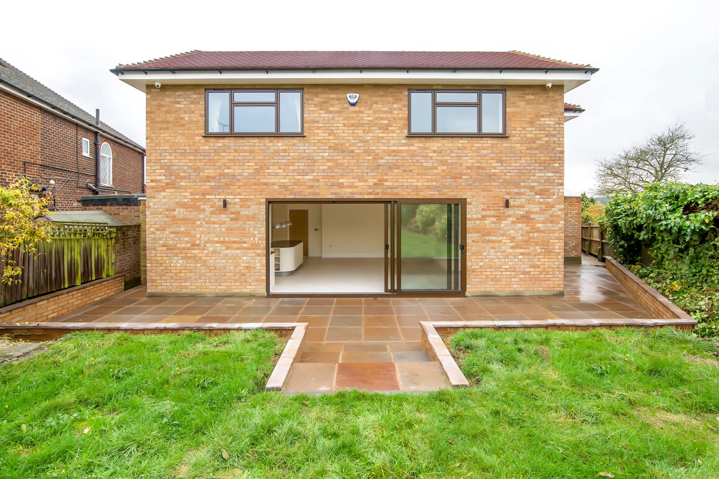 Rear elevation, terrace and lawn at Northiam Road